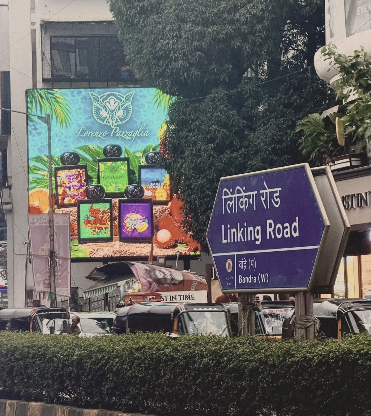 Lorenzo Pazzaglia digital billboard with the Linking Road street sign, Mumbai